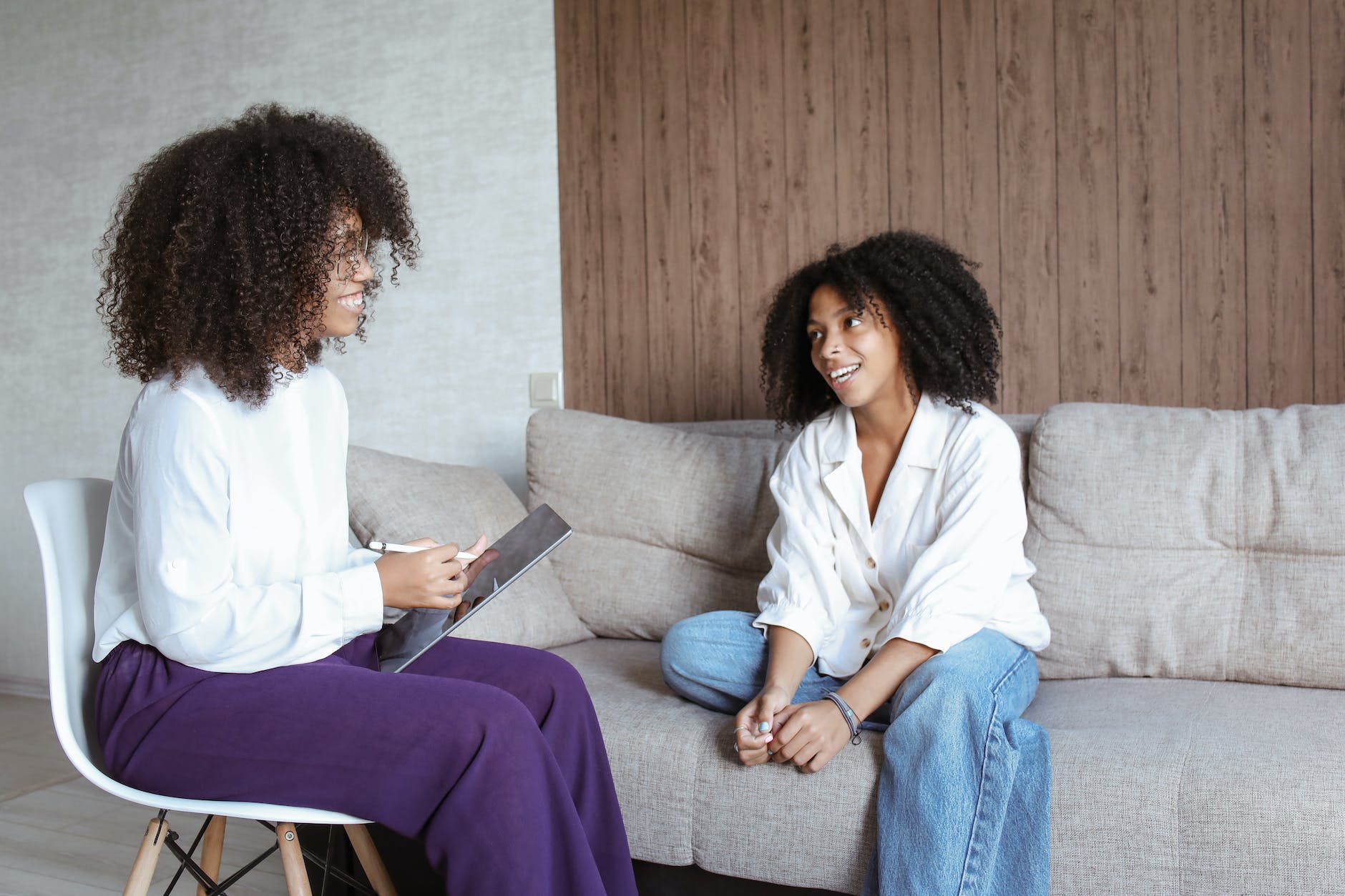 women having conversation while looking at each other