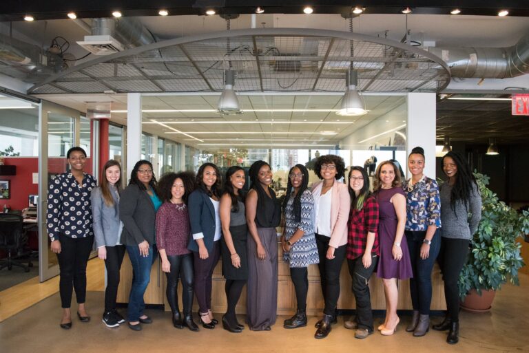 group of women standing near desk