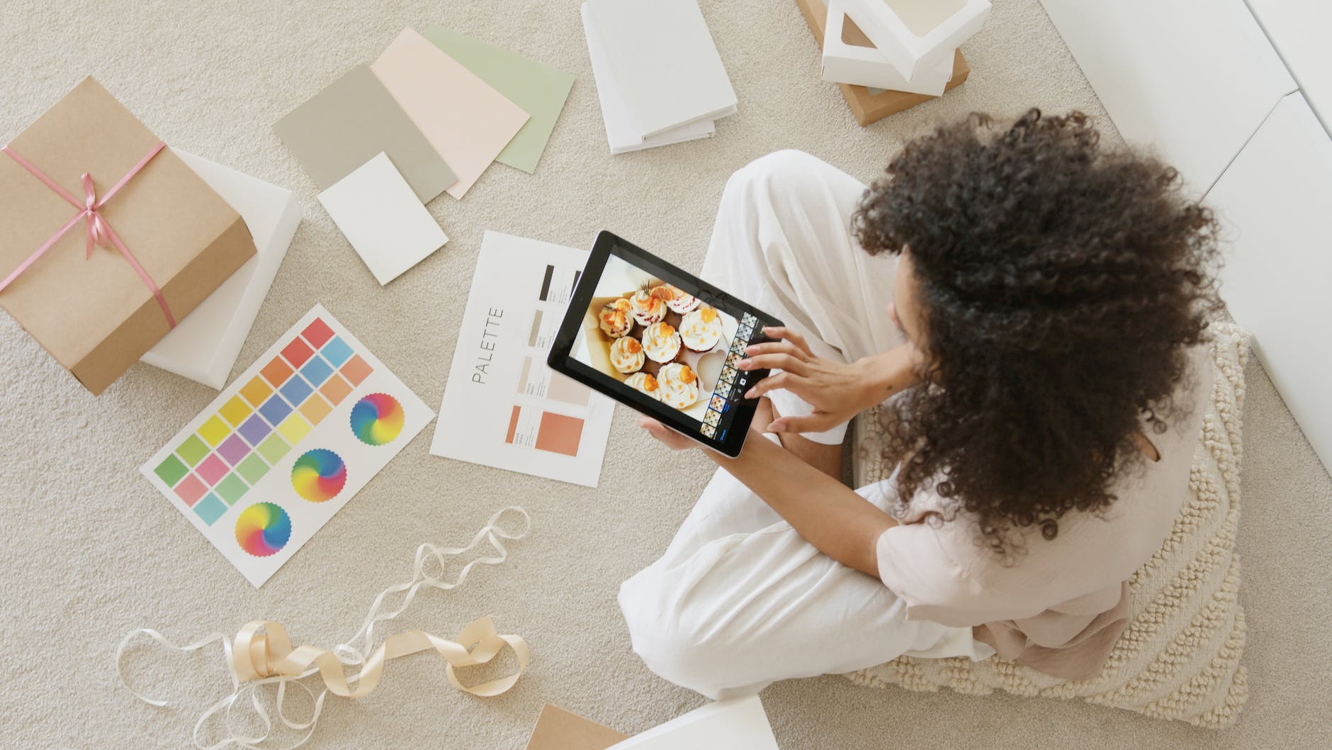 woman in white shirt holding black tablet computer